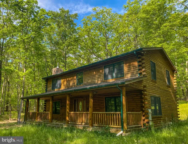 a view of brick house with a yard