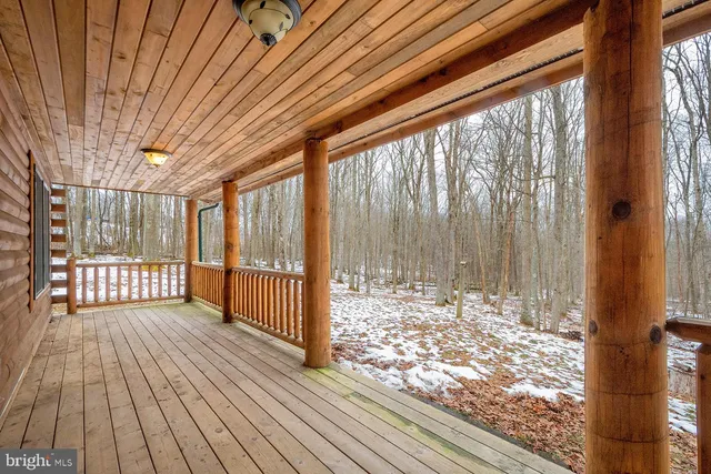 a view of empty room with wooden floor and floor to ceiling window