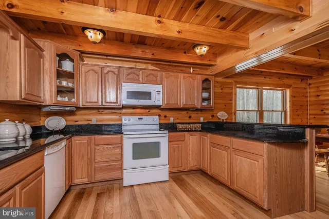 a kitchen with stainless steel appliances granite countertop a stove and cabinets