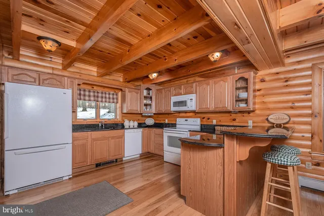 a kitchen with stainless steel appliances granite countertop a stove a sink dishwasher and a refrigerator