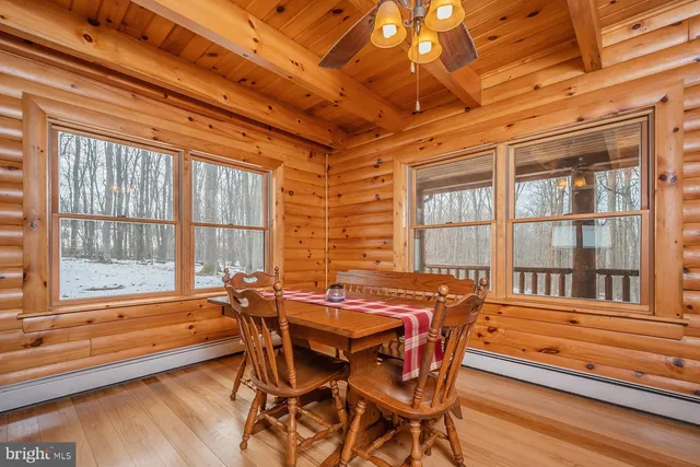 a dining room with furniture a chandelier and wooden floor