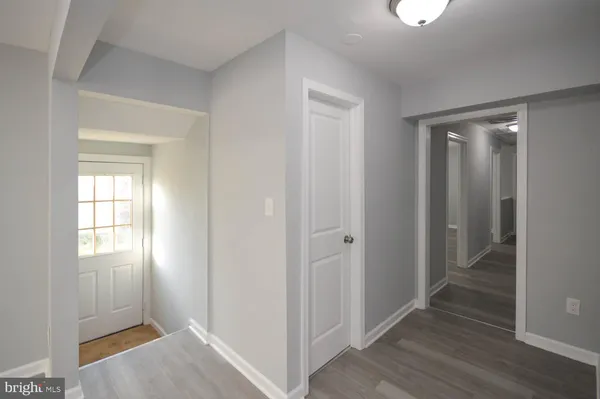 a view of hallway with wooden floor