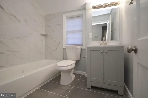 a bathroom with a toilet sink and bathtub