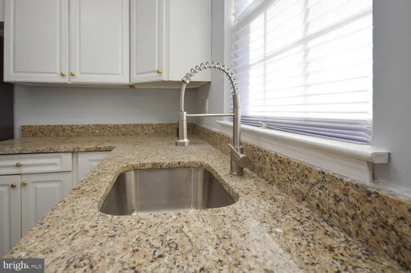 a kitchen with a sink cabinets and a window