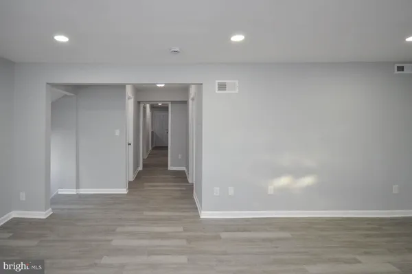 a view of an empty room and wooden floor