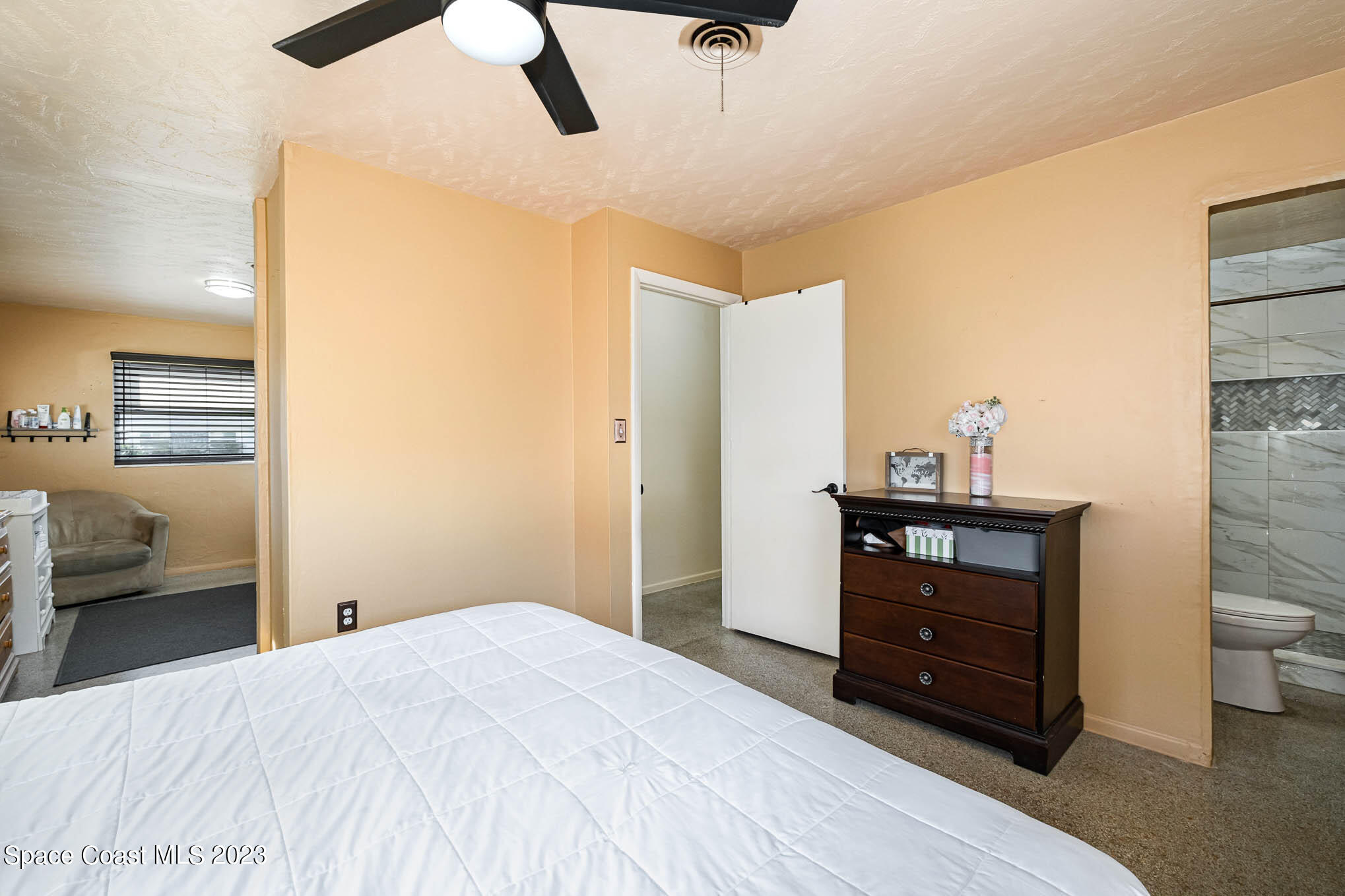 2710 Locksley Road Melbourne, FL 32935 - Photo 20 of 25 a bedroom with a bed and a dresser