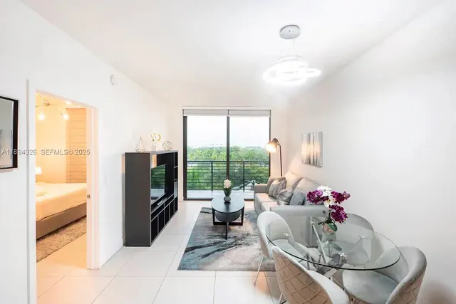 a living room with furniture and a floor to ceiling window