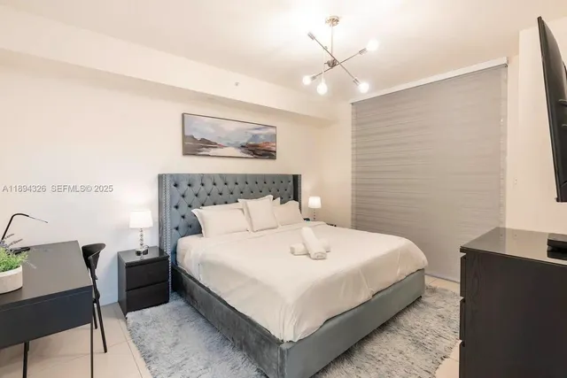 a bedroom with a bed and a table