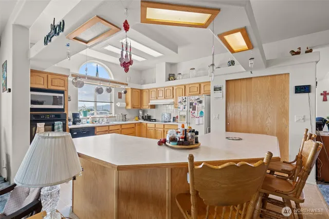 a view of a dining room with furniture and a chandelier