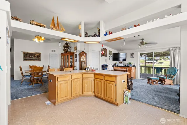 a kitchen with stainless steel appliances kitchen island granite countertop a sink and cabinets