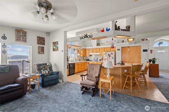 a view of a dining room with furniture and a chandelier