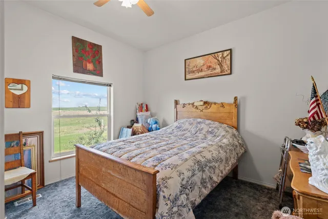 a bedroom with a bed and a bookshelf