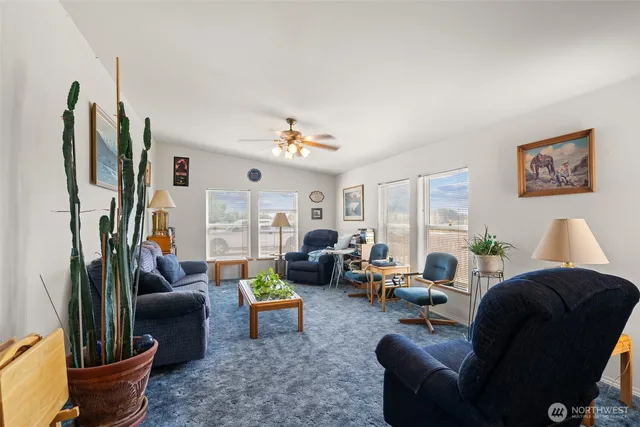 a living room with furniture a large window and a flat screen tv