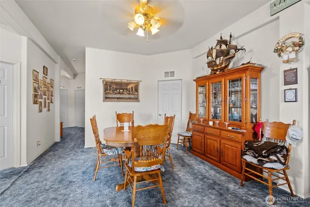 a dining room with furniture a rug and a chandelier