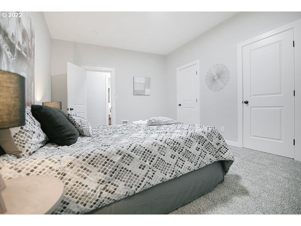 447 Russell Road Winlock, WA 98596 - Photo 13 of 32 a bedroom with a bed and a flat screen tv