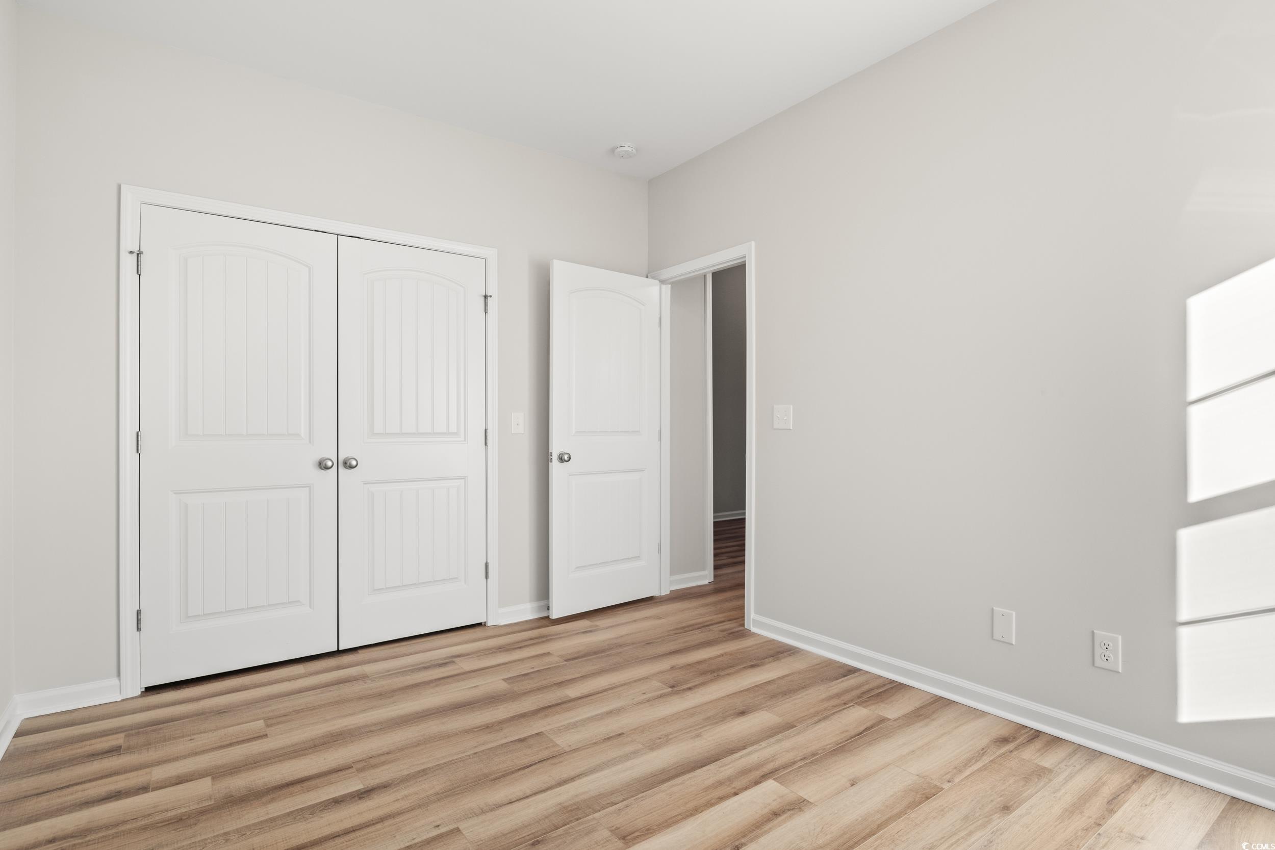 312 Lakota Loop Longs, SC 29568 - Photo 15 of 17 Unfurnished bedroom with a closet and light hardwo