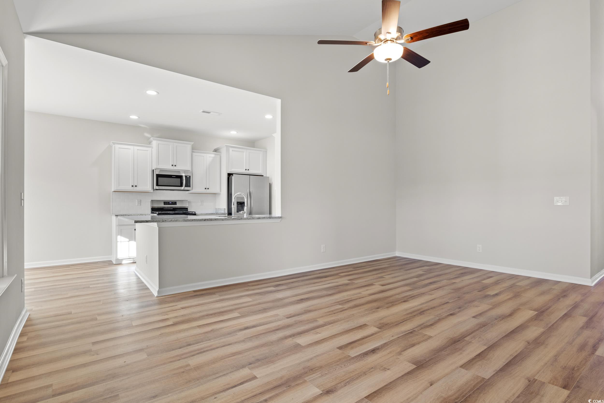 312 Lakota Loop Longs, SC 29568 - Photo 3 of 17 Unfurnished living room featuring ceiling fan, lig
