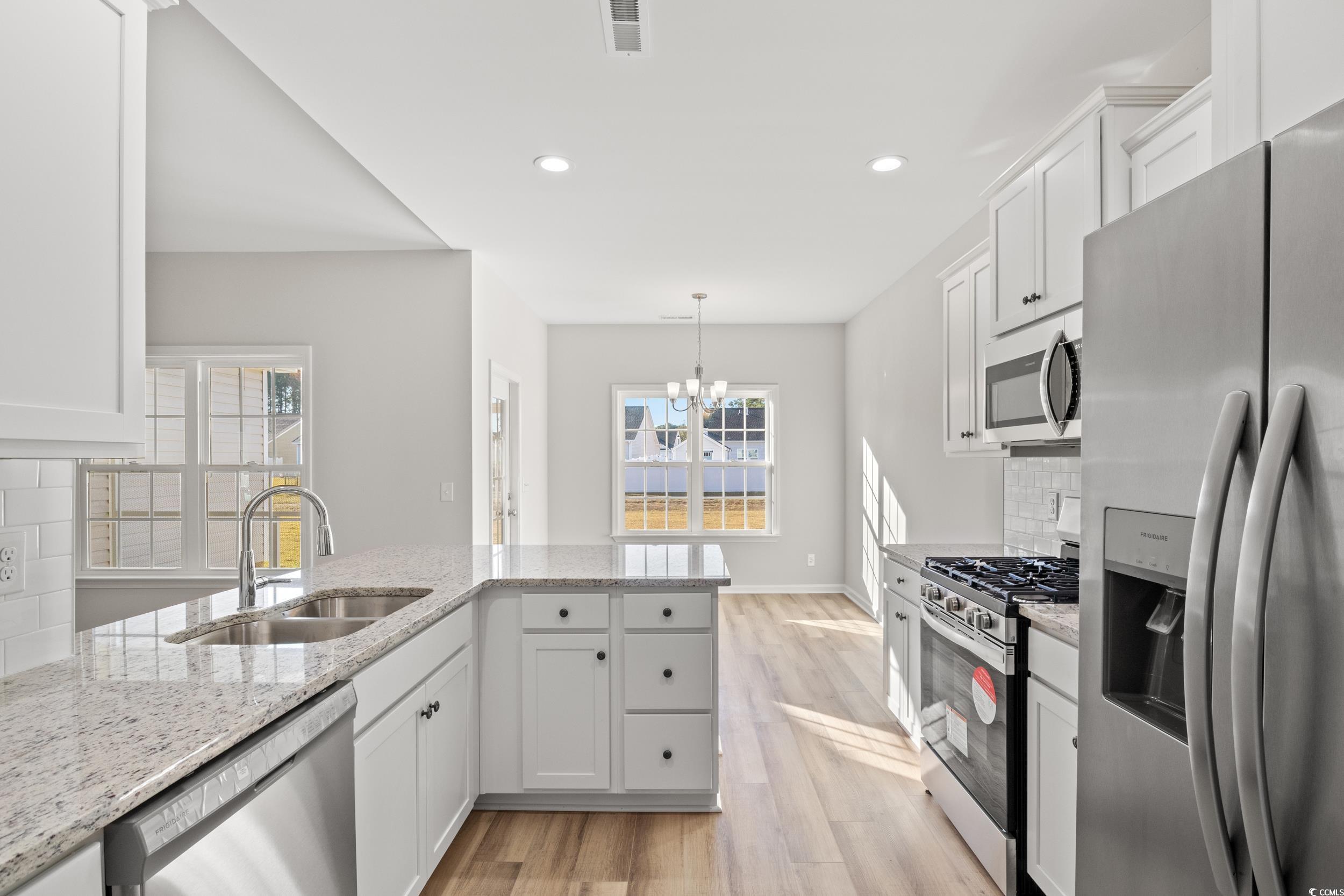 312 Lakota Loop Longs, SC 29568 - Photo 4 of 17 Kitchen with tasteful backsplash, sink, white cabi