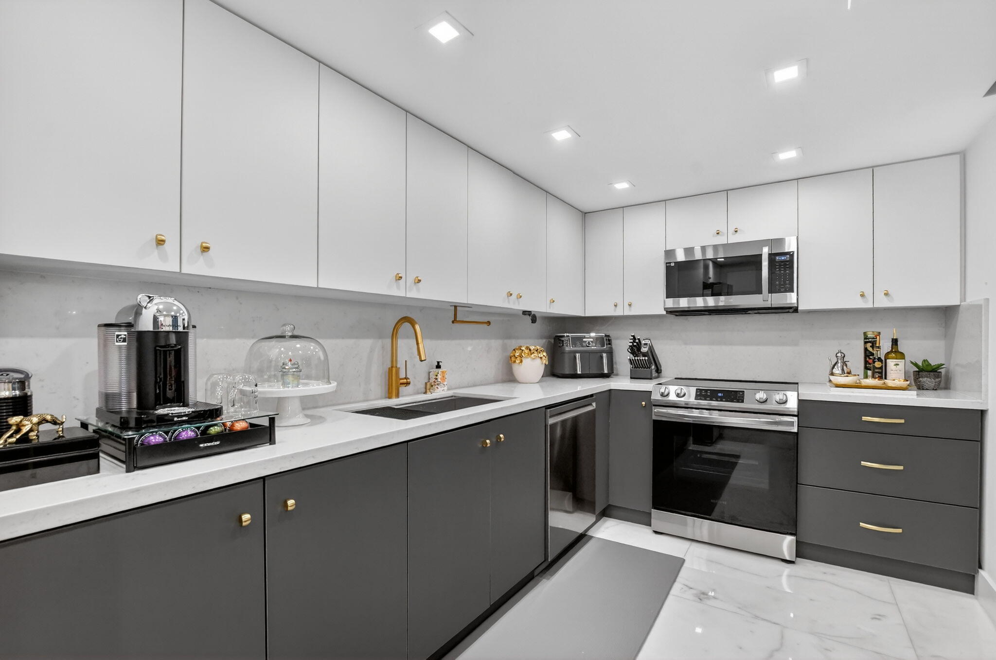 1834 Bridgewood Drive Boca Raton, FL 33434 - Photo 11 of 24 a kitchen with sink cabinets and stainless steel appliances