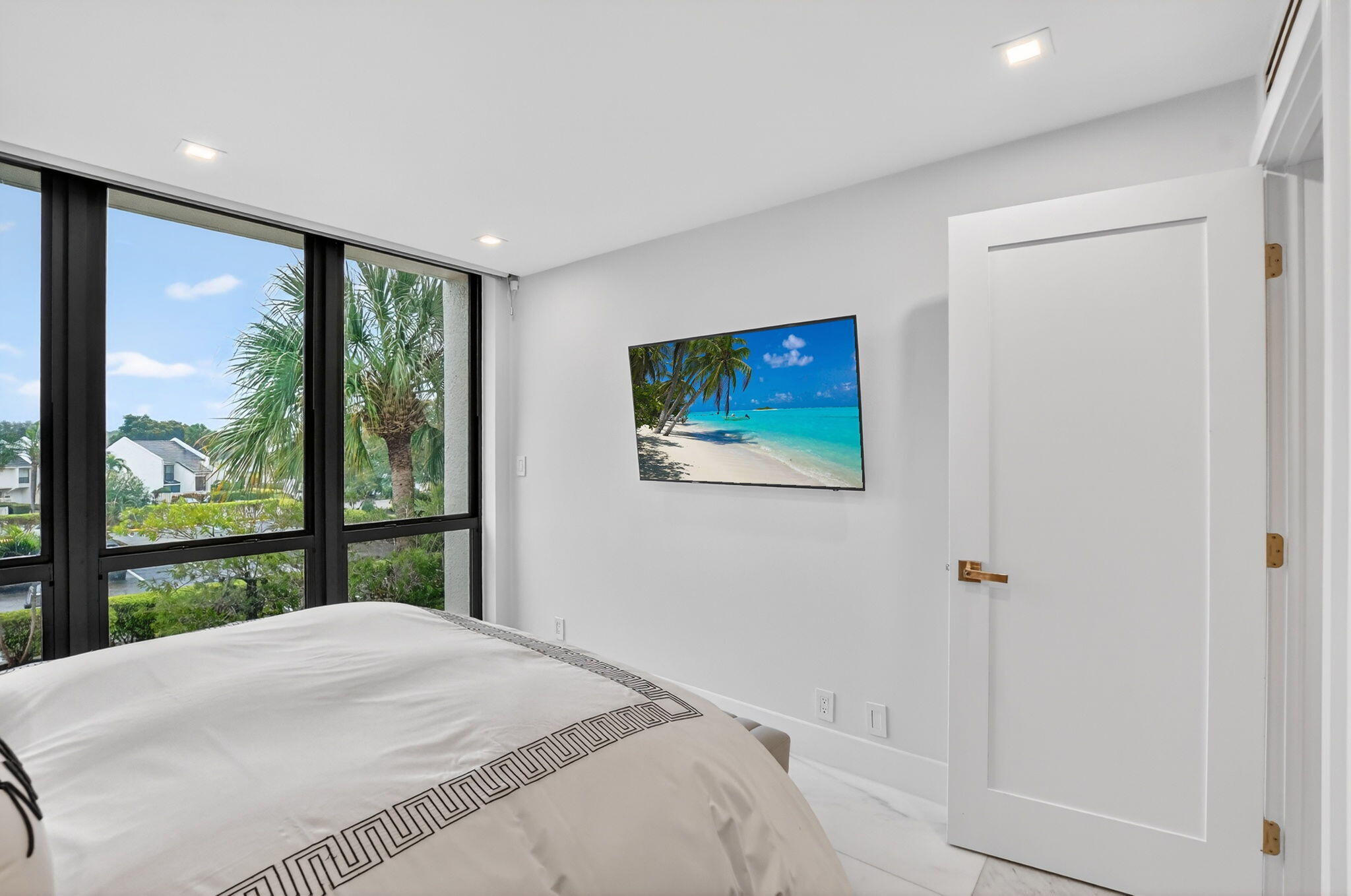 1834 Bridgewood Drive Boca Raton, FL 33434 - Photo 19 of 24 a bedroom with a bed and a large window