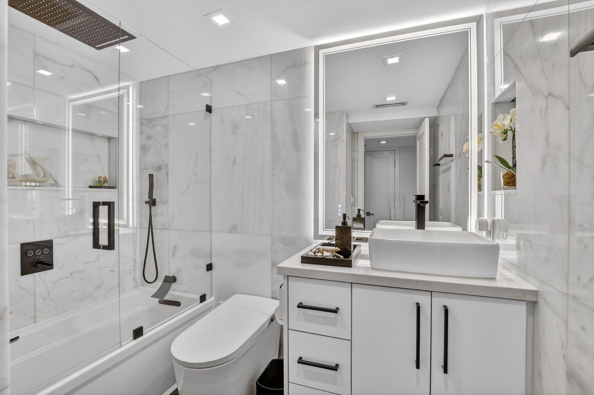 1834 Bridgewood Drive Boca Raton, FL 33434 - Photo 21 of 24 a bathroom with a bathtub shower sink and toilet