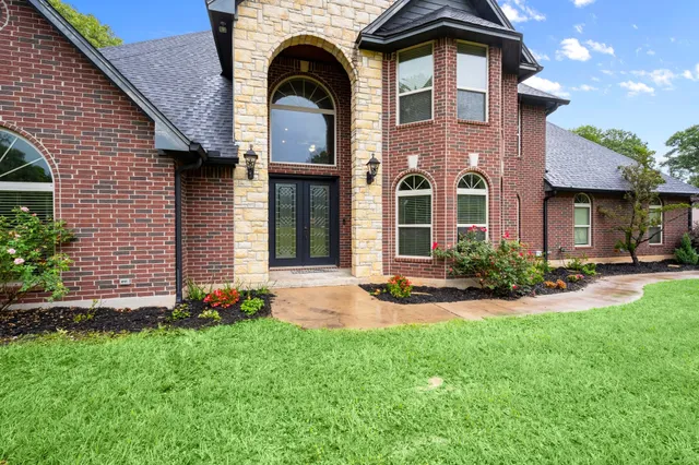 a front view of a house with a yard and garage