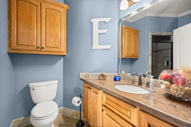 a bedroom with a bed a dresser and windows