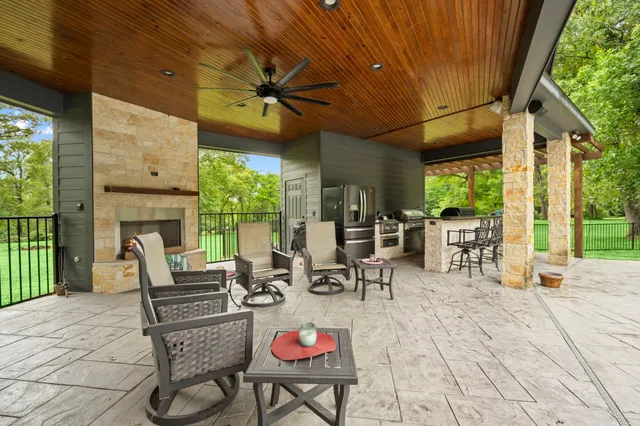 a front view of house with yard and trees in the background