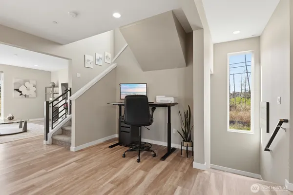 a view of workspace with wooden floor windows