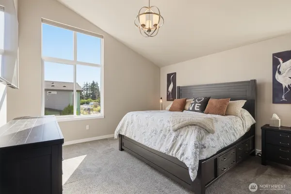 a bed sitting in a bedroom next to a window
