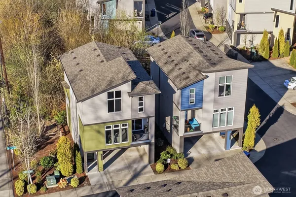 an aerial view of a house with large trees