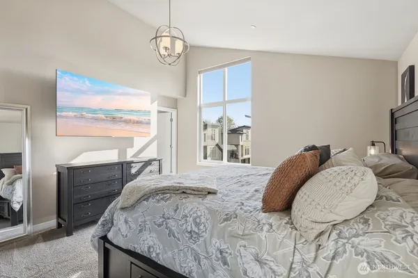 a bed sitting in a bedroom next to a window