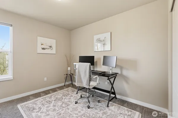 a workspace with furniture and a window