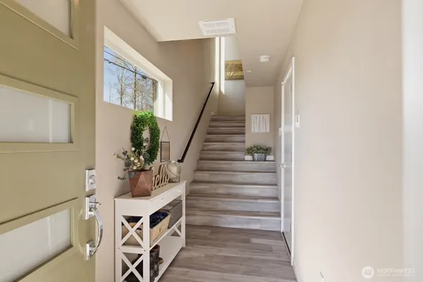 a view of an entryway with wooden floor
