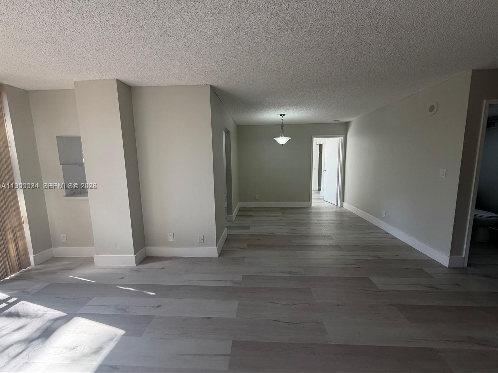 17021 North Bay Road, Unit 216 Sunny Isles Beach, FL 33160 - Photo 15 of 40 a view of a hallway with wooden floor