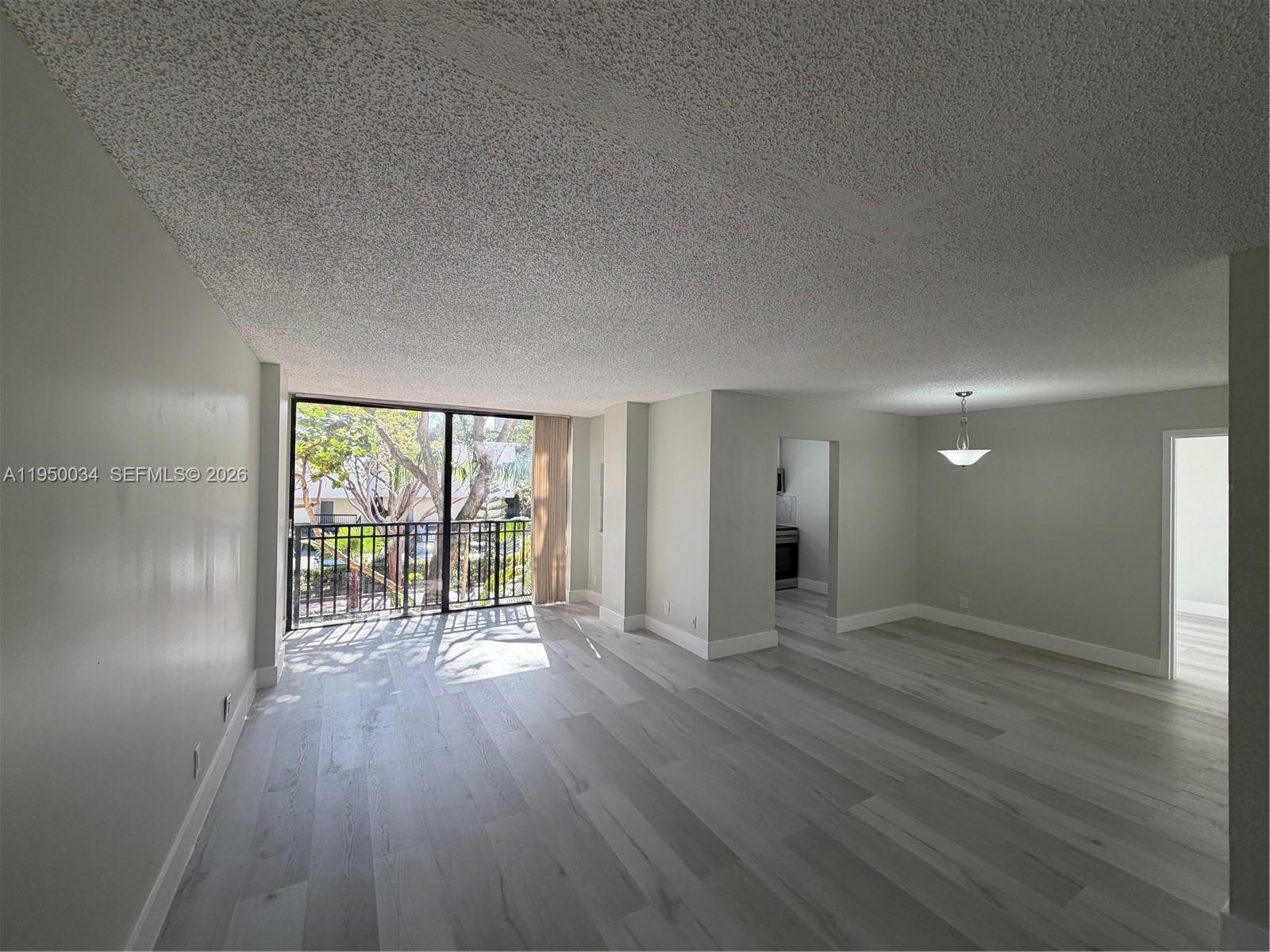 17021 North Bay Road, Unit 216 Sunny Isles Beach, FL 33160 - Photo 17 of 40 wooden floor in an empty room with a window
