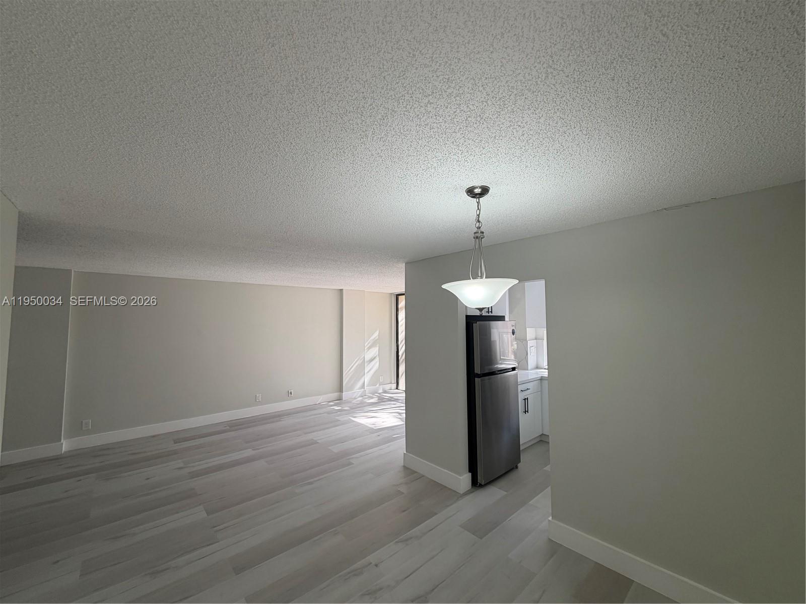 17021 North Bay Road, Unit 216 Sunny Isles Beach, FL 33160 - Photo 18 of 40 a view of a kitchen with a sink refrigerator and wooden floor