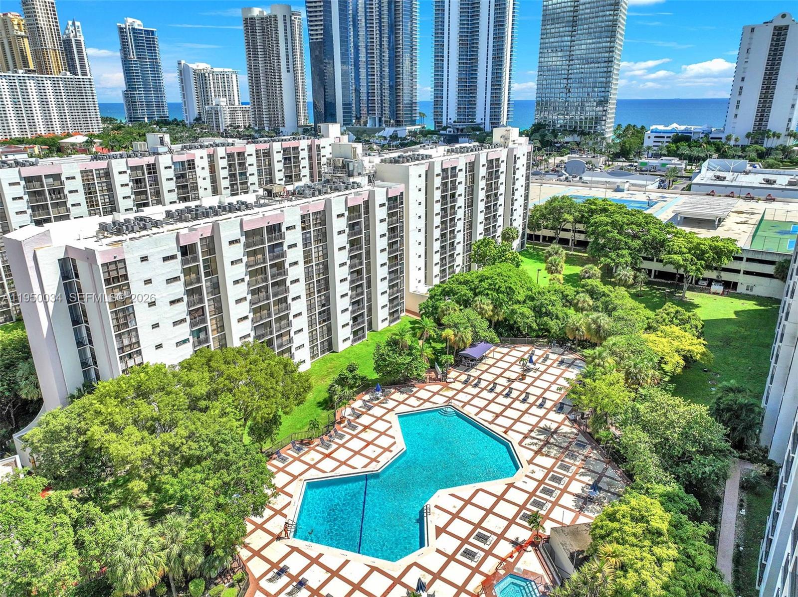 17021 North Bay Road, Unit 216 Sunny Isles Beach, FL 33160 - Photo 30 of 40 a view of a garden with tall buildings
