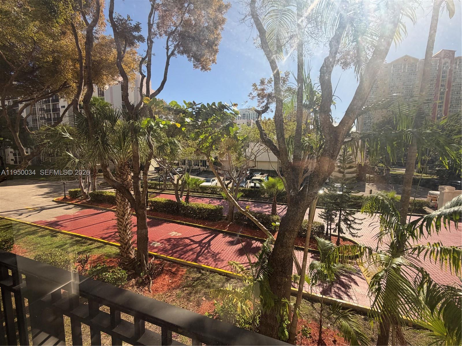17021 North Bay Road, Unit 216 Sunny Isles Beach, FL 33160 - Photo 7 of 40 a view of a yard with plants and trees