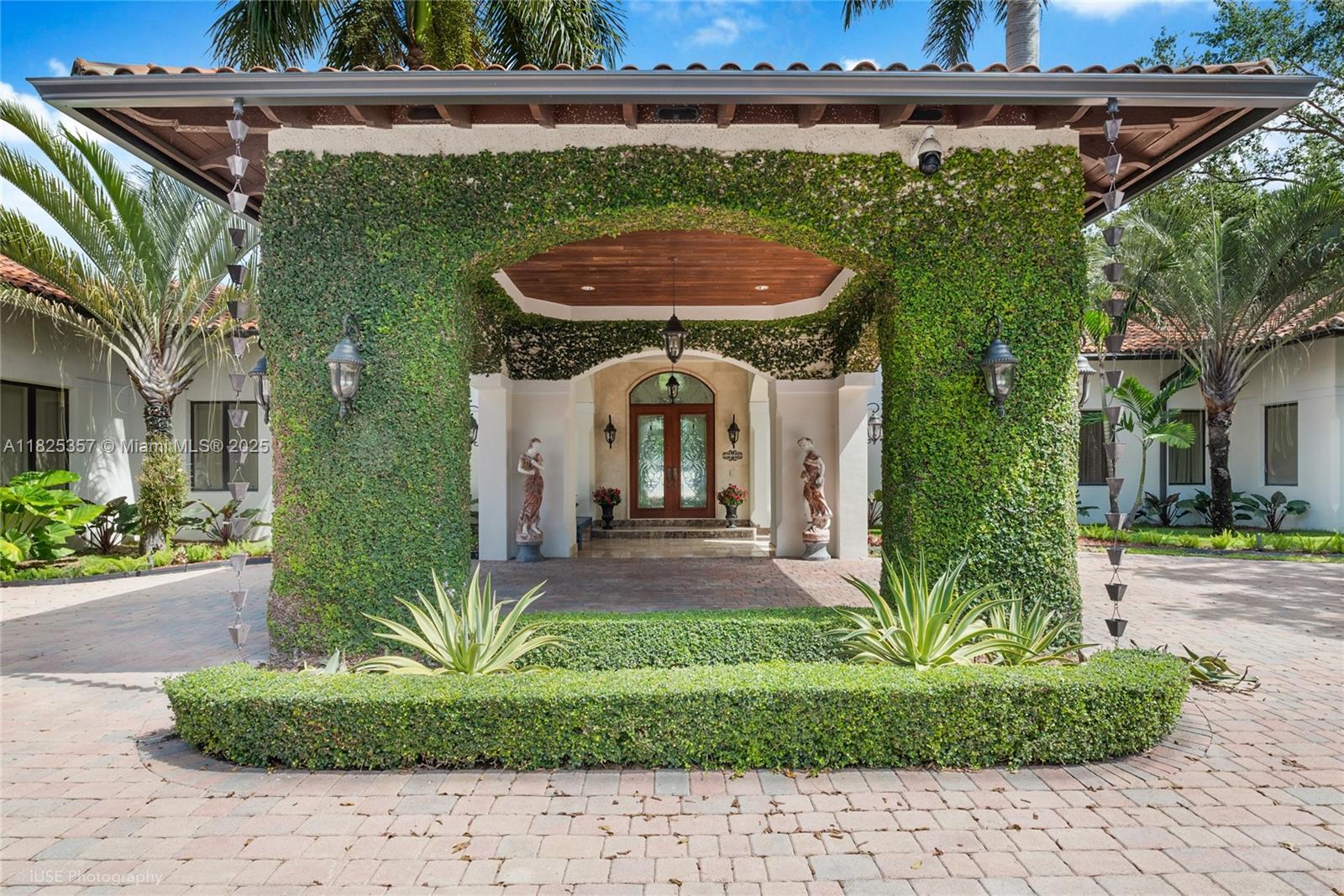 7405 Southwest 104th Street Pinecrest, FL 33156 - Photo 1 of 23 a front view of a house with garden
