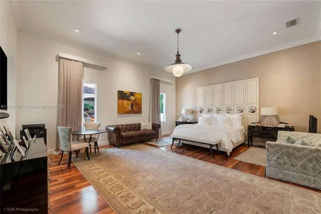 a spacious bedroom with a bed a couch and dresser