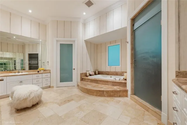 a spacious bathroom with a tub and shower