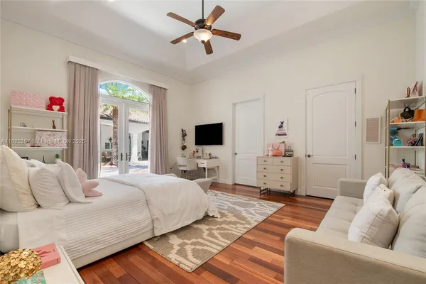 a bedroom with a bed furniture and a flat screen tv