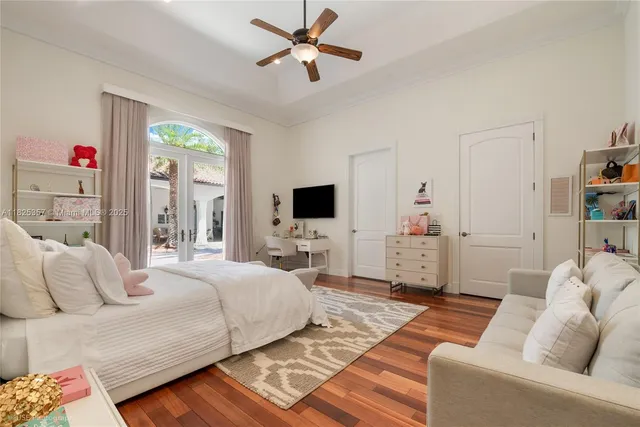 a bedroom with a bed furniture and a flat screen tv