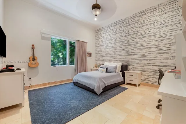 a bedroom with furniture and a window