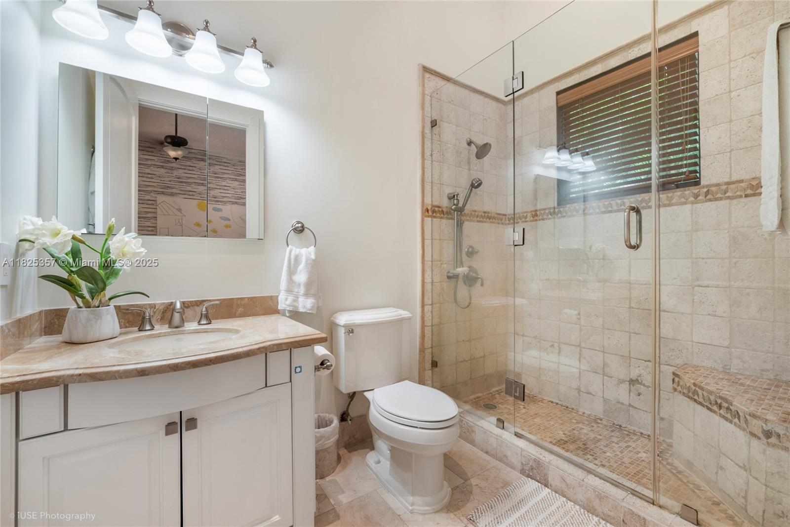 7405 Southwest 104th Street Pinecrest, FL 33156 - Photo 21 of 23 a bathroom with a granite countertop sink a toilet and shower
