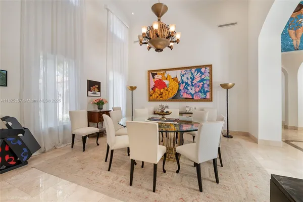 a view of a room with furniture and a chandelier