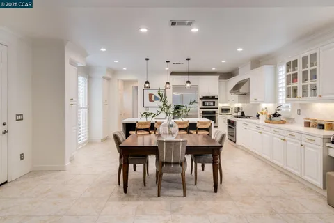 a large kitchen with a table and chairs