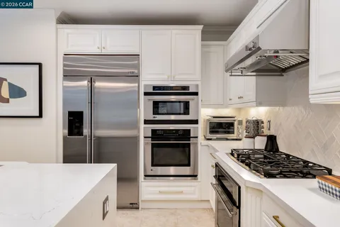 a kitchen with cabinets and stainless steel appliances