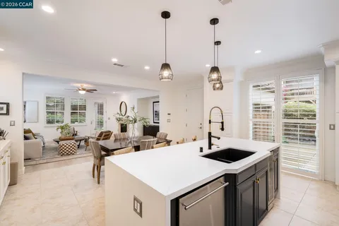 a large kitchen with a table and chairs